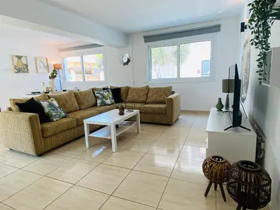a living room with a couch and a table at Serena's 2-BR Apartment in Larnaca in Larnaka