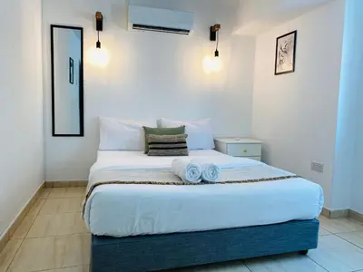 a bedroom with a large bed with towels on it at Serena's 2-BR Apartment in Larnaca in Larnaka