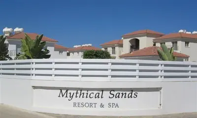 a sign on a white fence in front of a house at Mythical Sands Resort & Spa, Evilion Apartment in Paralimni