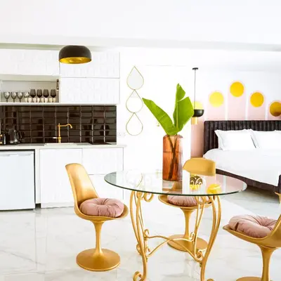 a kitchen and dining room with a glass table and two chairs at New Leventis Luxury Κing Suite 41-Central Location in Ayia Napa