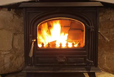 a fireplace with a fire inside of it at Agrovino Lofou in Lofou