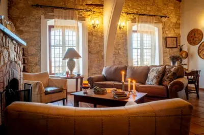 a living room with a couch and a table at Oinoessa Traditional Boutique Guest Houses in Lofou