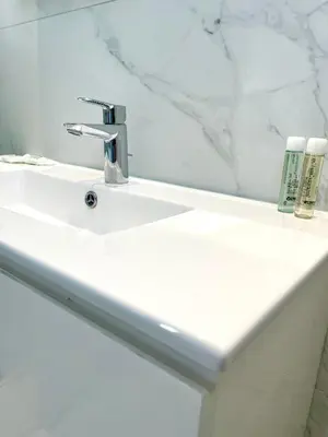 a bathroom sink with a faucet and a mirror at By the Beach Villa Natalya in Protaras