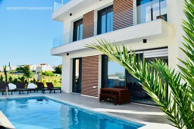 a villa with a swimming pool and a house at By the Beach Villa Natalya in Protaras