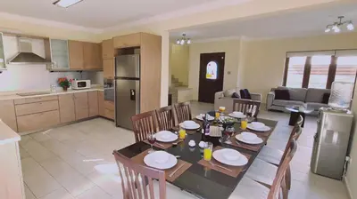 a kitchen and dining room with a table and chairs at STAY Ocean View Villa in Paralimni