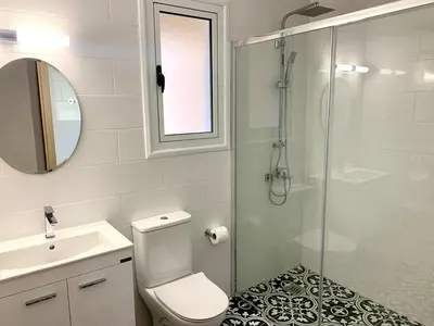 a bathroom with a shower and a toilet and a sink at Nissi3 B1 Lovely 1Bdr Ground Floor Apartment near Nissi Beach. in Ayia Napa