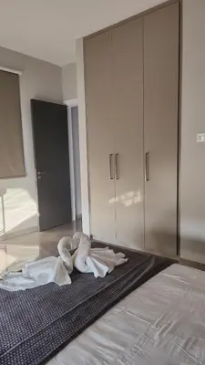 a bedroom with a bed with white towels on the floor at Hanna Panorama Villa in Protaras