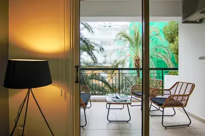 a room with a balcony with chairs and a lamp at Phaedrus Living City View Luxury Iras Flat 102 in Nicosia