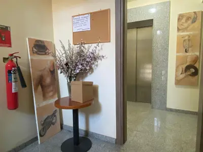 a vase of flowers on a table in a hallway at Appartments in the historic center near beach in Limassol
