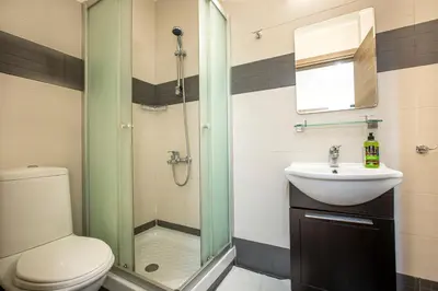 a bathroom with a shower and a toilet and a sink at Appartments in the historic center near beach in Limassol