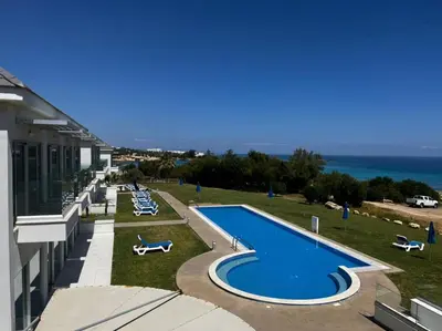 a view of a swimming pool on the side of a building at Ocean Suites Luxury Apartments in Protaras