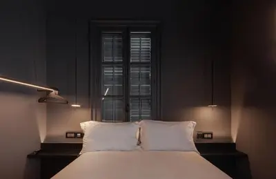 a bed with white pillows in a room with a window at The Sendal Boutique Hotel in Nicosia