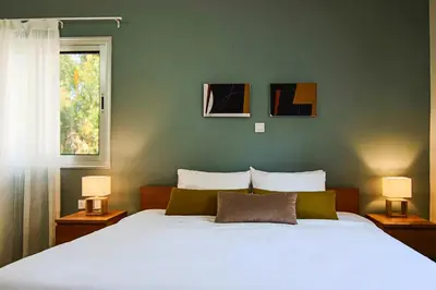 a bedroom with a large white bed with two lamps at Phaedrus Living City View Luxury Flat Harbour 04 in Larnaka