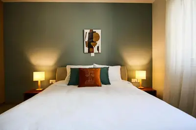 a bedroom with a large white bed with two lamps at Phaedrus Living City View Luxury Flat Harbour 04 in Larnaka