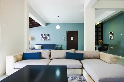 a living room with a couch and a table at Phaedrus Living City View Luxury Flat Harbour 04 in Larnaka