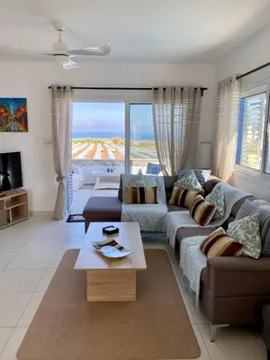 a living room with a couch and a table at Villa Kapparis Sunrise in Paralimni