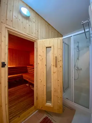 a wooden cabin with a shower in a bathroom at Villa Kapparis Sunrise in Paralimni
