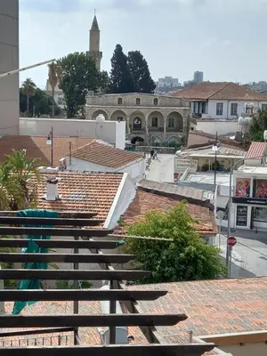 a group of wooden benches sitting on top of roofs at Old Town studio apartment in Larnaka