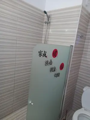 a bathroom with a toilet with writing on the wall at Old Town studio apartment in Larnaka