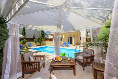 a villa with a swimming pool and a patio at Protaras Villa Athamas Blue in Protaras