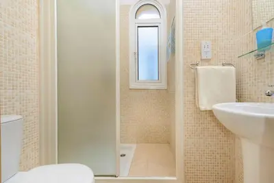 a bathroom with a shower and a toilet and a sink at Protaras Villa Athamas Blue in Protaras