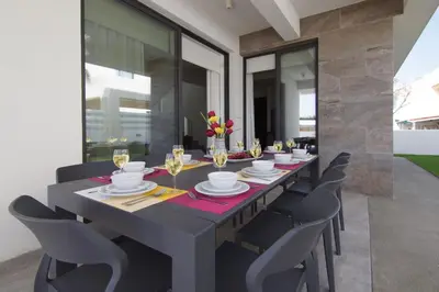 a dining room with a long table and chairs at Villa Queen Valeria in Protaras