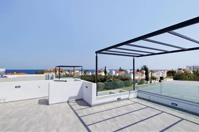 a patio with a view of the ocean from a house at Villa Queen Valeria in Protaras