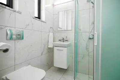 a bathroom with a toilet and a glass shower at Villa Queen Valeria in Protaras