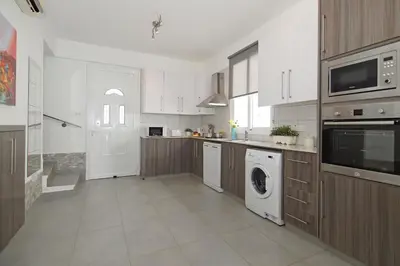 a large kitchen with a washer and dryer at Villa Aphrodisia - Seafront in Ayia Napa