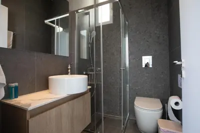 a bathroom with a sink and a shower and a toilet at Vie Bleu 3 Bedroom Villas in Protaras