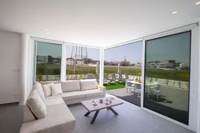 a living room with a couch and a table at Vie Bleu 3 Bedroom Villas in Protaras
