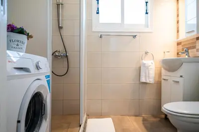 a bathroom with a washing machine and a sink at Protaras View Villas in Protaras