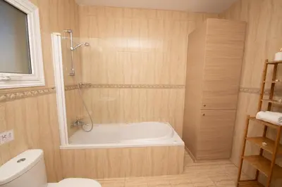 a bathroom with a bath tub and a toilet at Villa Helena in Ayia Napa