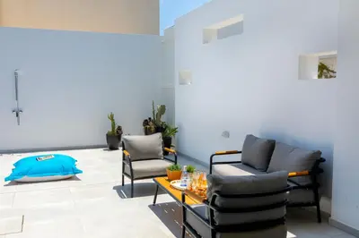 a living room with two chairs and a table at Protaras Almaria Villa 16 in Protaras