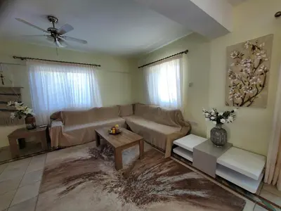 a living room with a couch and a table at Villa - Sleeps 6 free parking & heated pool in Protaras