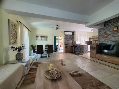 a living room with a couch and a table at Villa - Sleeps 6 free parking & heated pool in Protaras