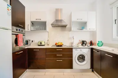 a kitchen with a washing machine and a washer at Villa Emily in Protaras