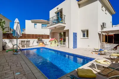 a swimming pool in the backyard of a house at Villa Emily in Protaras