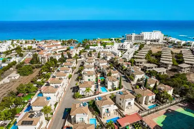 an aerial view of a resort near the ocean at Villa Emily in Protaras