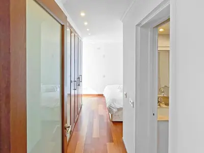 a bedroom with a door leading to a bed at 180° SEAVIEW Apt. right on famous beach promenade in Larnaka