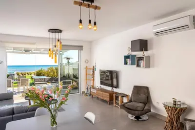 a living room with a view of the ocean at Ayia Thekla Seafront Villa Dagi in Ayia Napa