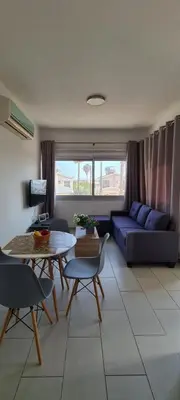 a living room with a couch and a table at Lovely 1betroom apartment near the beach in Pyla