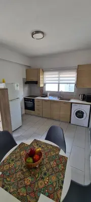 a kitchen with a table with a bowl of fruit on it at Lovely 1betroom apartment near the beach in Pyla