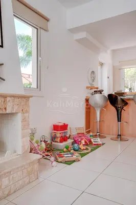a pile of toys on a floor in a kitchen with a fireplace at Villa Hanna in Protaras