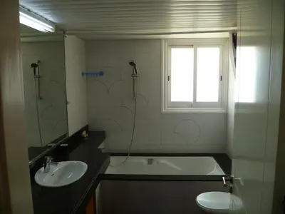 a bathroom with a sink and a tub and a toilet at Datacom House - The Sky Blue Room in Nicosia