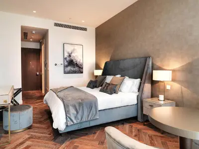 a bedroom with a large bed and a table at Limassol Del Mar in Limassol