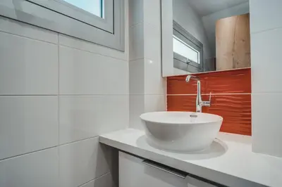 a bathroom with a white bowl sink on a counter at Stay in Style in Modern 3 Bedroom Villas Near Nissi Beach & Square in Ayia Napa