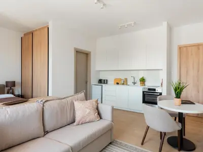a living room with a couch and a table at Armonta Residences by BeCyprus in Limassol