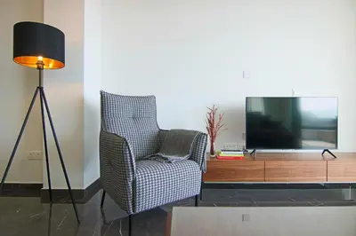 a living room with a chair and a television at Phaedrus Living: Sea View Anna Residence 202 in Limassol
