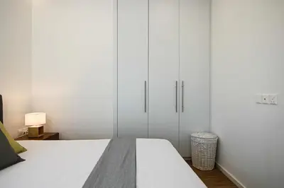 a bedroom with white cabinets and a white bed at Phaedrus Living: Sea View Anna Residence 202 in Limassol